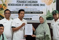 Perwakilan dari Food Bank dan pemilik dapur MBG memperlihatkan dokumen hasil penandatanganan komitmen kerja sama di bidang distribusi pangan berlebih di SPPG, Sabtu (11/7/26).